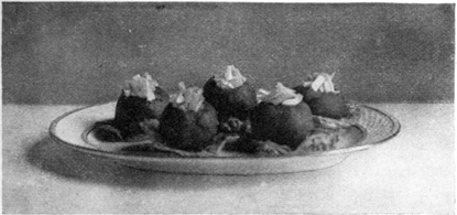 TOMATOES STUFFED WITH CELERY AND MAYONNAISE STANDING ON
LETTUCE LEAVES.