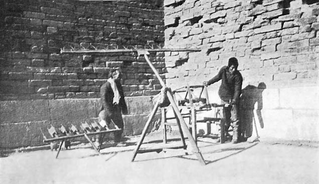 Silk-reeling done in the open under the Walls of Peking.