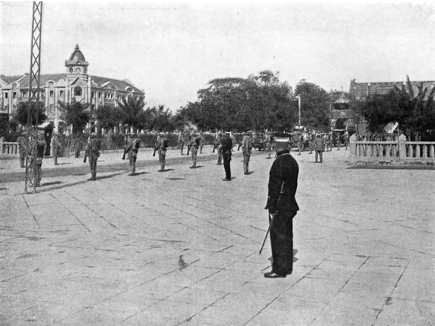 Modern Peking: The Palace Entrance lined with Troops.
Note the New-type Chinese Policeman in foreground.