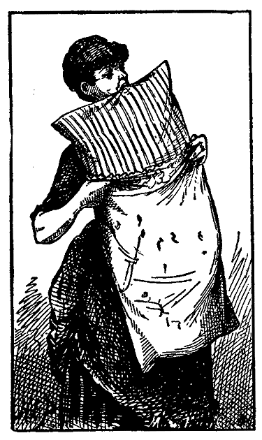 A woman holds a pillow in her teeth and puts a pillowcase on it.