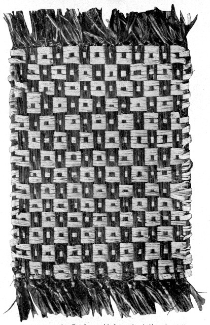 A woven mat of raffia, from a kindergarten pattern in
green and the natural color of the raffia