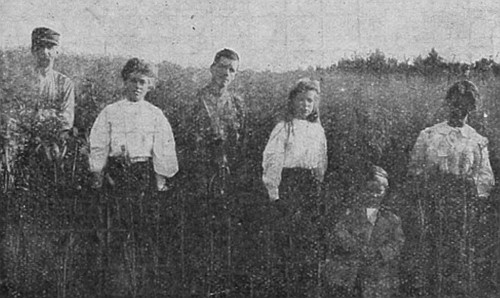 A healthy family from Nebraska, now living in Western
Canada. Observe the height of the oats. The crop yielded 70 bushels per
acre.