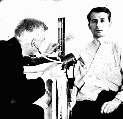 Fig. 25.—Observation by the auscultatory method and a mercury instrument. One hand
regulates the stop cock which releases air gradually.