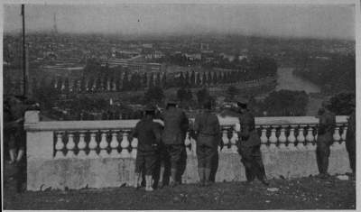 SO THIS IS PARIS
A. E. F. Boys, guests of our A. R. C. in its great hospital at St. Cloud, look down about the "Queen City of
the World"