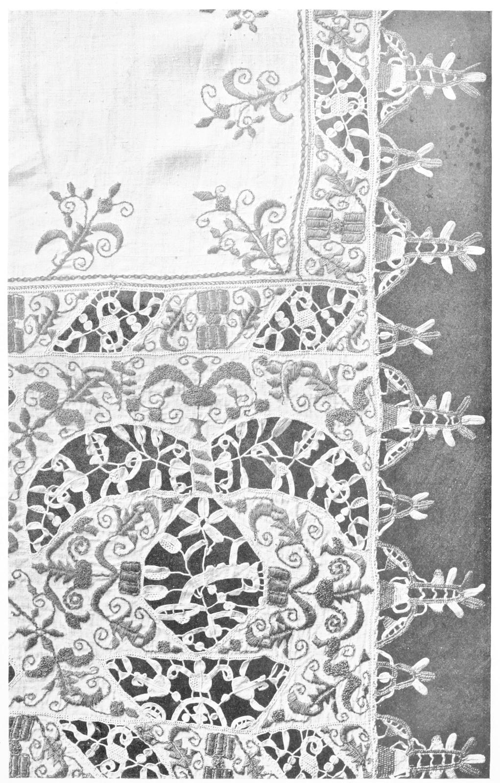 Corner of table cloth with cutouts and
    embroidery