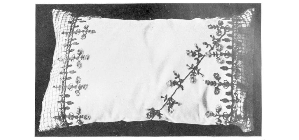 Pale cushion decorated with dark lace